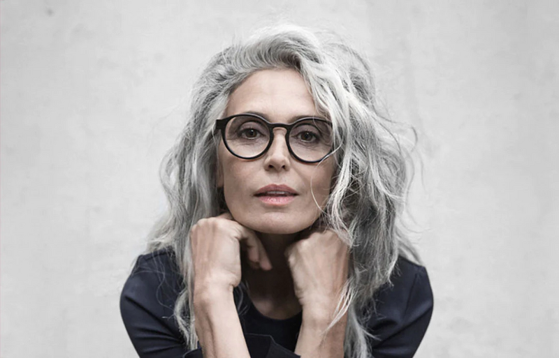 File:Lady-with-long-grey-hair-wearing-round-black-gvvlasses.webp